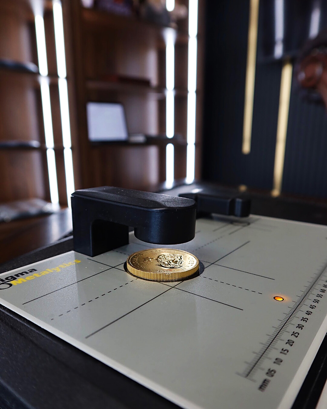 A second check on the same coin. The verifier reads straight through the metal to confirm it is solid, not plated.