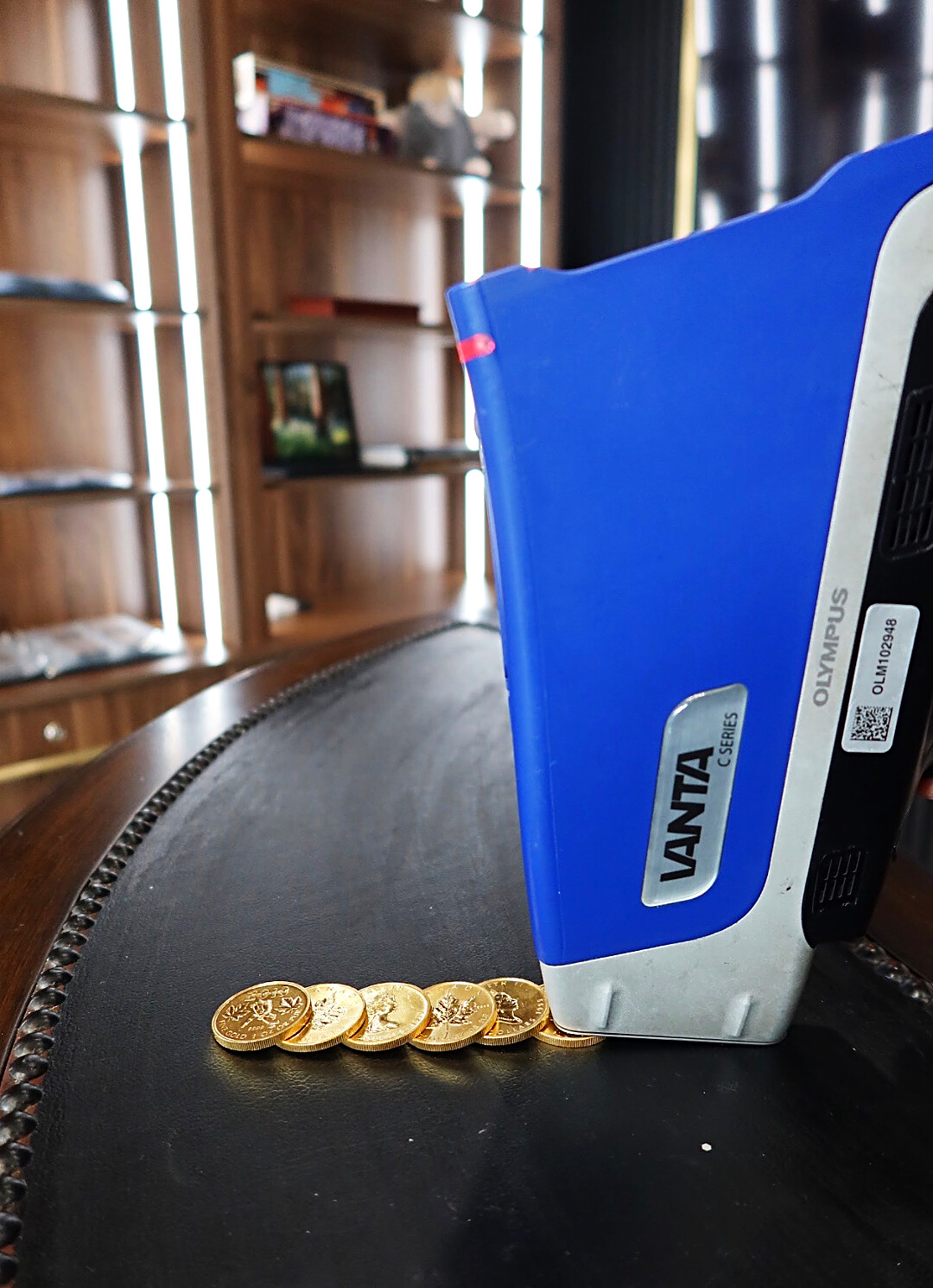 Our handheld X-ray analyzer reading a row of one-ounce gold coins. No acid, no filing, no scratch tests.